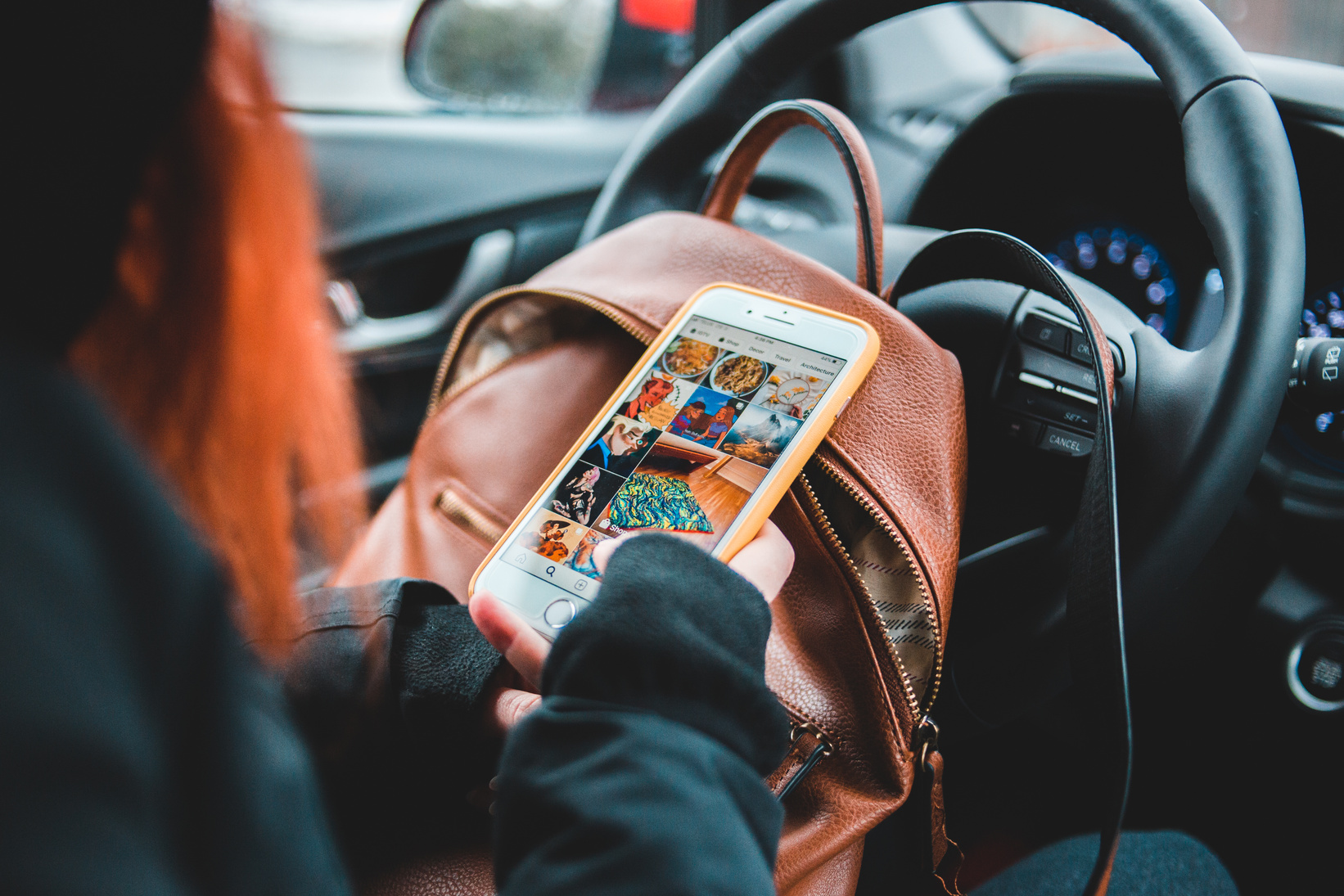 Crop woman surfing social media in car